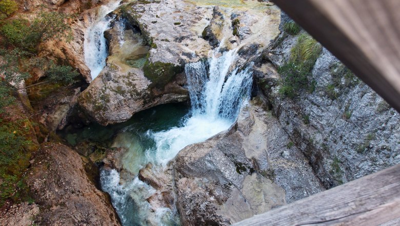 View from above of a waterfall in a rocky gorge.