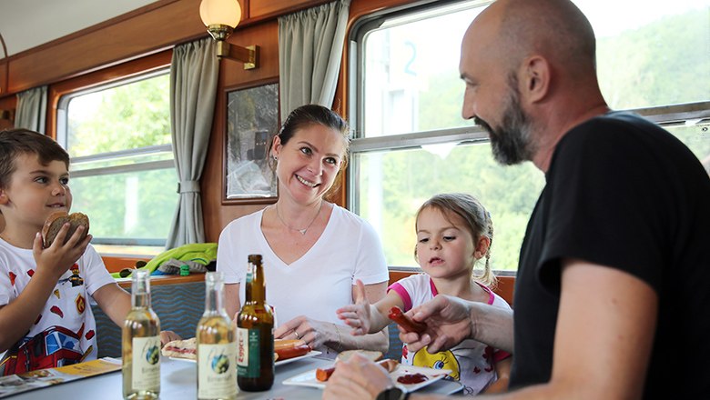 Familie genießt Essen im Speisewagen