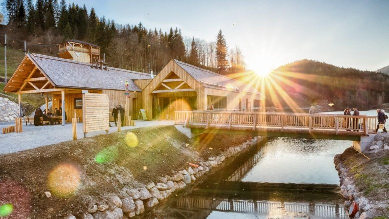 &Ouml;tscher base Wienerbruck with wooden buildings and bridge at sunset.