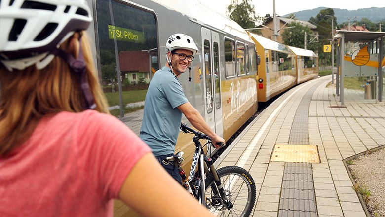 zwei Fahrradfahrer stehen vor Mariazellerbahn