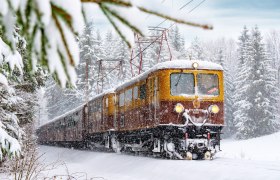 Der Zug Ötscherbär fährt durch die Schneelandschaft